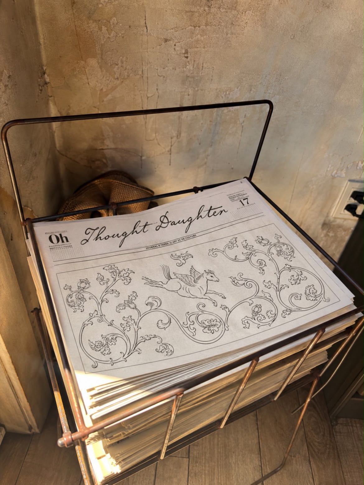 Thought Daughter newspaper and prints on a vintage stand